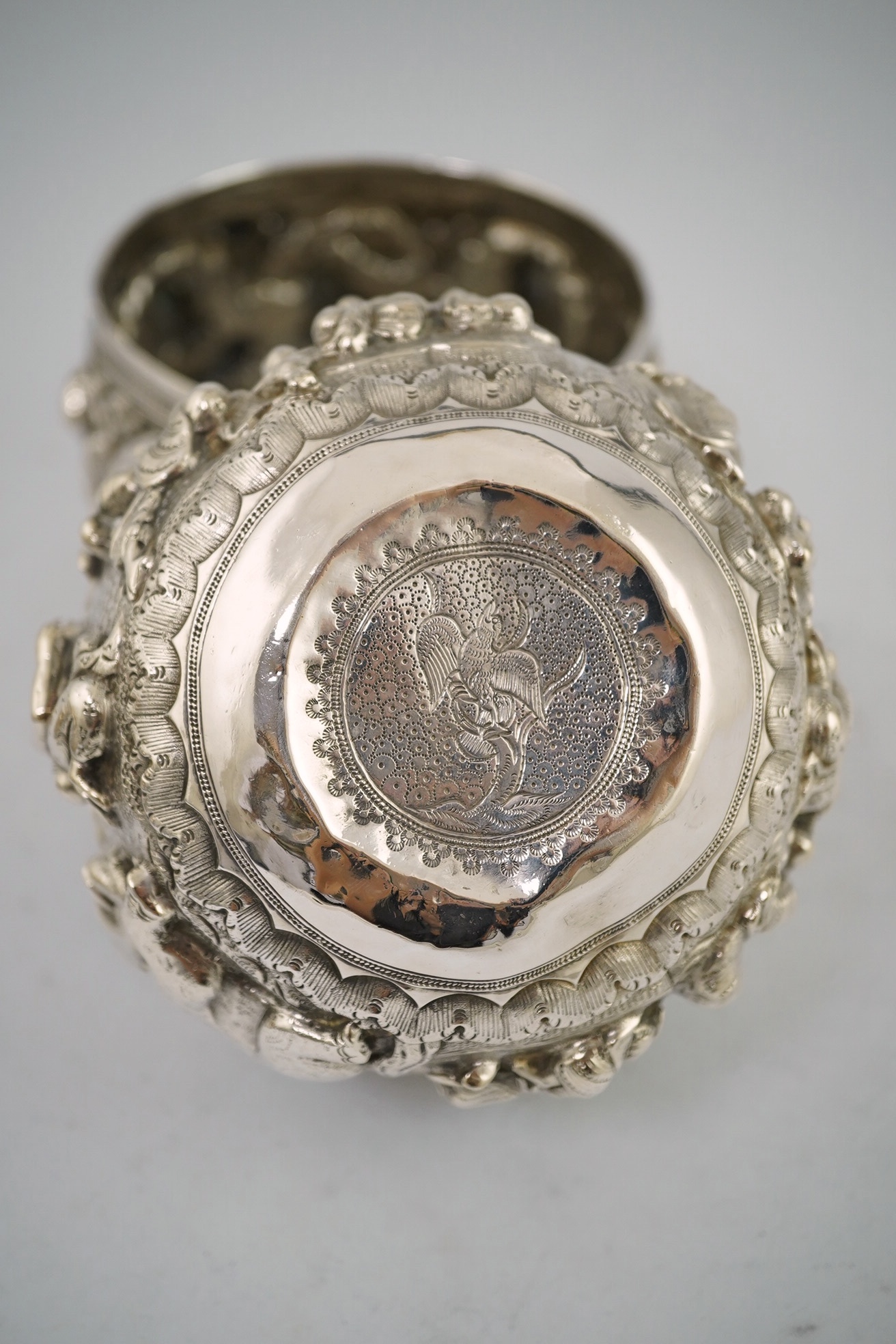 A pair of Burmese white metal bowls, embossed with figures, 12cm diameter, 220 and 224g and a plainer bowl, 110g. Condition – fair